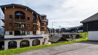 a apartment building with a balcony and a playground at LES ARCADES - 310 - Appt accueillant 4-6 pers in Morillon