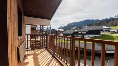 a balcony with a view of a house at LES ARCADES - 310 - Appt accueillant 4-6 pers in Morillon