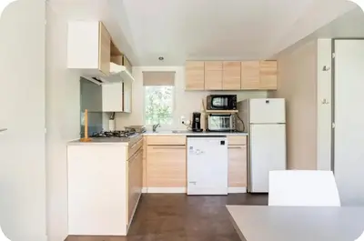 a kitchen with white appliances and wooden cabinets at MH F4 Ski Rando Loisirs Proche Chamonix 6 pers 300AK in Passy