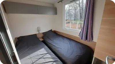 a bed in a small room with a window at MH F4 Ski Rando Loisirs Proche Chamonix 6 pers 300AK in Passy