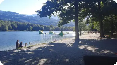 a group of people standing on the shore of a lake at MH F4 Ski Rando Loisirs Proche Chamonix 6 pers 300AK in Passy