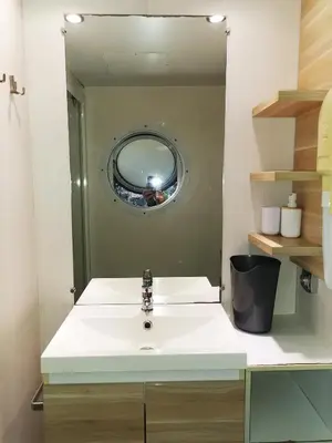 a bathroom with a white sink and a mirror at MH F4 Ski Rando Loisirs Proche Chamonix 6 pers 300AK in Passy