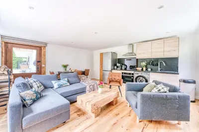 a living room with two blue couches and a table at Appartement de Luxe avec Jacuzzi, Vue Montagne et Jardin in Chamonix-Mont-Blanc