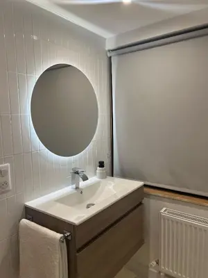a bathroom with a sink and a mirror at Appartement de Luxe avec Jacuzzi, Vue Montagne et Jardin in Chamonix-Mont-Blanc