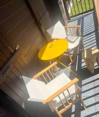 an overhead view of a table and chairs on a porch at Appartement à Megève in Demi-Quartier