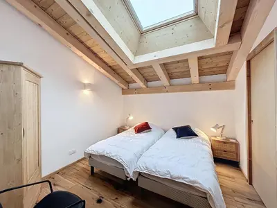 a bedroom with a bed and a skylight at Appartement de Standing 4 Chambres au Pied des Pistes à Combloux - FR-1-560-122 in Combloux
