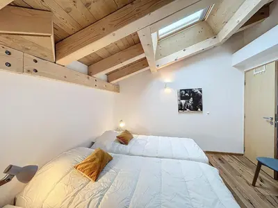 a bedroom with a large bed in a room with wooden ceilings at Appartement de Standing 4 Chambres au Pied des Pistes à Combloux - FR-1-560-122 in Combloux