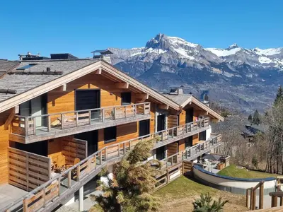 a house with a mountain in the background at Appartement de Standing 4 Chambres au Pied des Pistes à Combloux - FR-1-560-122 in Combloux