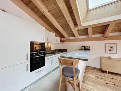 a kitchen with white cabinets and a wooden ceiling at Appartement de Standing 4 Chambres au Pied des Pistes à Combloux - FR-1-560-122 in Combloux