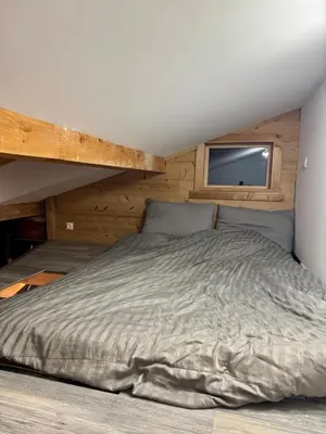 a large bed in a room with a window at The Mountain View in Les Houches