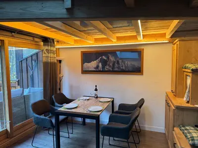 a dining room with a table and chairs at The Mountain View in Les Houches