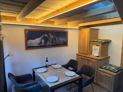 a dining room with a table and chairs at The Mountain View in Les Houches