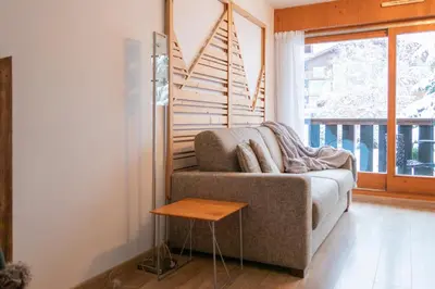 a living room with a couch and a table at Au centre du village station de ski in Les Contamines-Montjoie