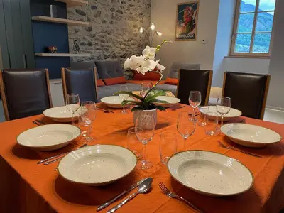 a kitchen with a table with glasses and flowers on it at Face au Mont-Blanc, au cœur des plus grands domaines skiables de Haute-Savoie in Sallanches