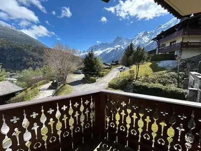 a winter view from a balcony with snow covered mountains at Les Houches vue magnifique avec piscine,pied des pistes de ski,garage in Les Houches