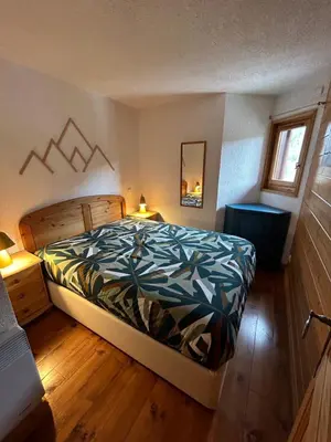 a bedroom with a king sized bed in a room at Les Houches vue magnifique avec piscine,pied des pistes de ski,garage in Les Houches