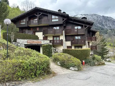 a large building with balconies on the side of it at Les Houches vue magnifique avec piscine,pied des pistes de ski,garage in Les Houches