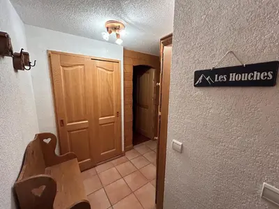 a hallway with a door and a sign on the wall at Les Houches vue magnifique avec piscine,pied des pistes de ski,garage in Les Houches