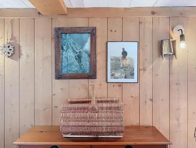 a room with a wooden wall with a bench and a mirror at Le cosy refuge in Chamonix-Mont-Blanc