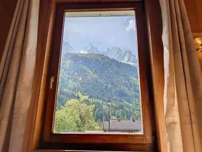 a window with a view of a mountain at Le cosy refuge in Chamonix-Mont-Blanc