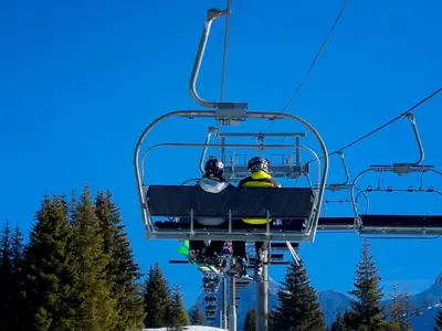 a group of people riding a ski lift at Le cosy refuge in Chamonix-Mont-Blanc