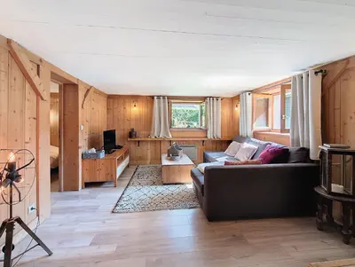 a living room with a couch and a table at Le cosy refuge in Chamonix-Mont-Blanc