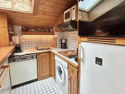 a kitchen with a white refrigerator and a dishwasher at Appartement cosy 2P+cabine, 6 couchages, proche télécabine Jaillet et centre, balcon Sud, garage privé - FR-1-597-176 in Megève