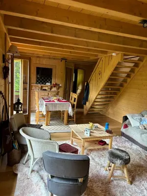a living room with a couch and a staircase at Bienvenue dans notre chalet à Saint-Gervais-les-Bains in Saint-Gervais-les-Bains
