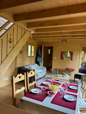 a dining room with a table in a cabin at Bienvenue dans notre chalet à Saint-Gervais-les-Bains in Saint-Gervais-les-Bains