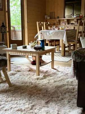 a living room with a table and a dining room at Bienvenue dans notre chalet à Saint-Gervais-les-Bains in Saint-Gervais-les-Bains