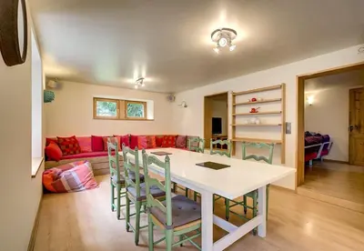 a living room with a table and chairs and a couch at Apartment Serenite in Chamonix-Mont-Blanc