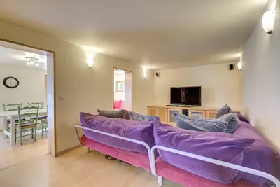 a living room with a purple couch and a tv at Apartment Serenite in Chamonix-Mont-Blanc