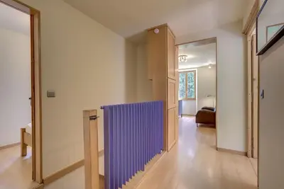 a hallway with a purple partition in a house at Apartment Serenite in Chamonix-Mont-Blanc