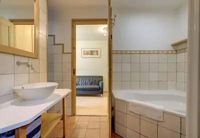 a bathroom with a tub and a sink at Apartment Serenite in Chamonix-Mont-Blanc