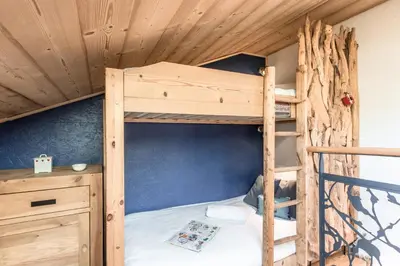 a bunk bed in a cabin with a wooden ceiling at Balcon du Mont-Blanc - Calme - Central in Chamonix-Mont-Blanc