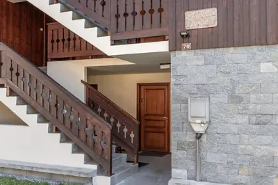 a stairway with a wooden door and a stone wall at Balcon du Mont-Blanc - Calme - Central in Chamonix-Mont-Blanc