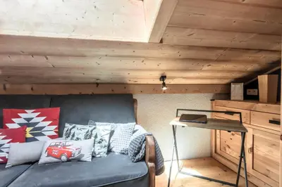a couch in a room with a wooden ceiling at Balcon du Mont-Blanc - Calme - Central in Chamonix-Mont-Blanc