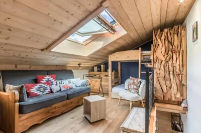 a living room with a couch and a bunk bed at Balcon du Mont-Blanc - Calme - Central in Chamonix-Mont-Blanc