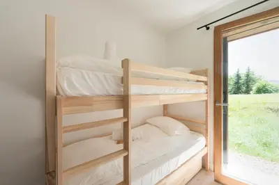 a room with two bunk beds and a window at SUNNY MEGEVE - Luxury Flat with services in Megève