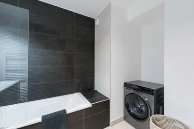 a laundry room with a washer and dryer in it at SUNNY MEGEVE - Luxury Flat with services in Megève