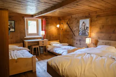 a bedroom with two beds and a desk in it at Refuge Margot in Chamonix-Mont-Blanc