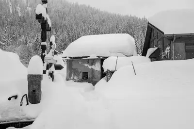 a snow covered parking lot with cars covered in snow at Refuge Margot in Chamonix-Mont-Blanc