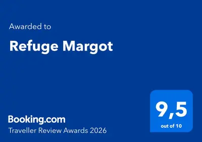 a blue sign that reads refugee margot with the textrated to refuge magnet at Refuge Margot in Chamonix-Mont-Blanc