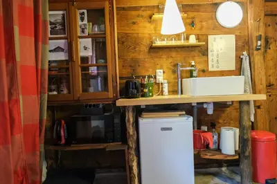a kitchen with a sink and a refrigerator at Refuge Margot in Chamonix-Mont-Blanc