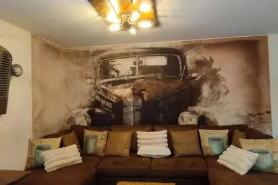 a mural of a truck on a wall with a couch at Bivouac & Sacs à dos - Loft classé, avec escape game sur demande in Sixt