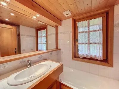 a bathroom with a sink and a tub and a mirror at Appartement 3P avec parking proche des pistes à Combloux - FR-1-560-135 in Combloux