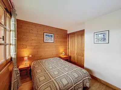 a bedroom with a bed and two tables in it at Appartement 3P avec parking proche des pistes à Combloux - FR-1-560-135 in Combloux
