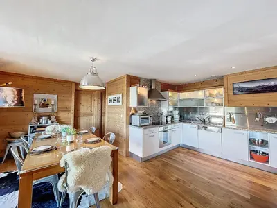 a kitchen with a table and a dining room at Appartement 4 pièces avec piscine couverte à Combloux - FR-1-560-127 in Combloux
