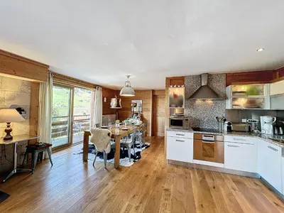 a kitchen with a table and a dining room at Appartement 4 pièces avec piscine couverte à Combloux - FR-1-560-127 in Combloux