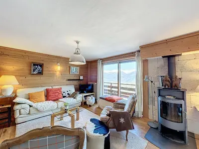a living room with a couch and a fireplace at Appartement 4 pièces avec piscine couverte à Combloux - FR-1-560-127 in Combloux